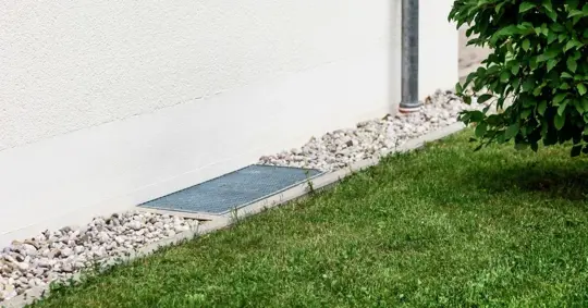 Drain and gravel along property wall