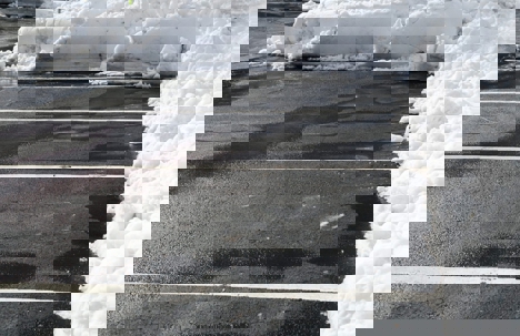 Winter parking lot with piles of snow