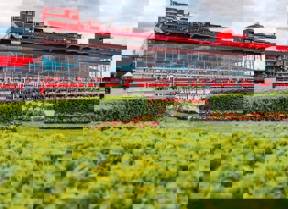 A professional landscape outside a large building with red and white trim.