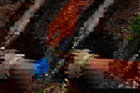 A person repairs an in-ground irrigation system