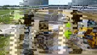 Landscaping team installing large stones at a commercial property.