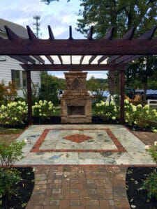 Outdoor space with a fireplace